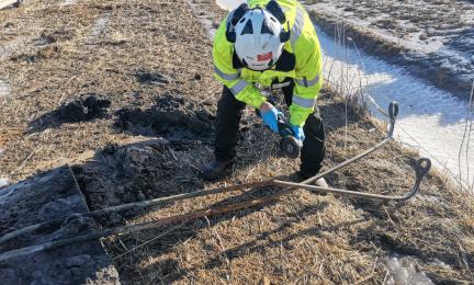 Kuvassa huomioasuinen tutkija leikkaa rälläkällä terästankoa poikki.
