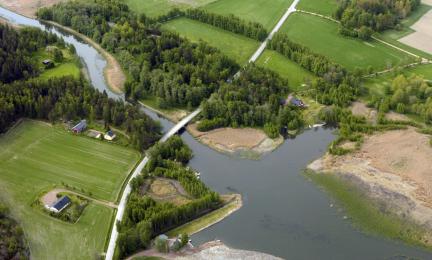 Green fields and a river.